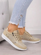 Pair of navy suede trainers shown from above with laces tied in a bow and crystal mesh toe