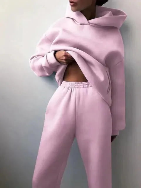 Woman posed casually showing the drop-shoulder sleeves and loose hoodie fit