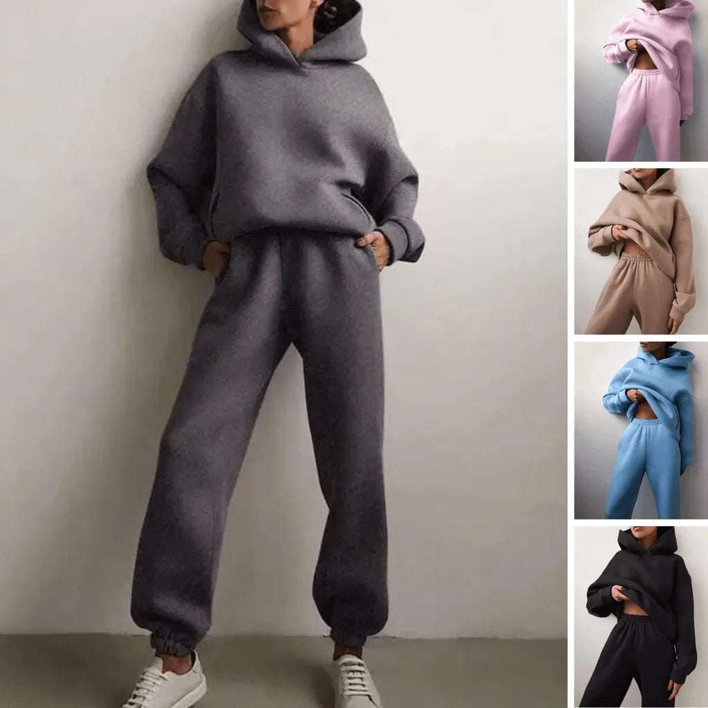 Full outfit view highlighting the matching hoodie and jogger tracksuit paired with white trainers