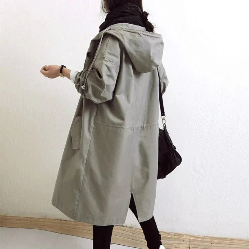 Back view of a grey hooded trench coat showing the elasticated cuffs and back seam detailing