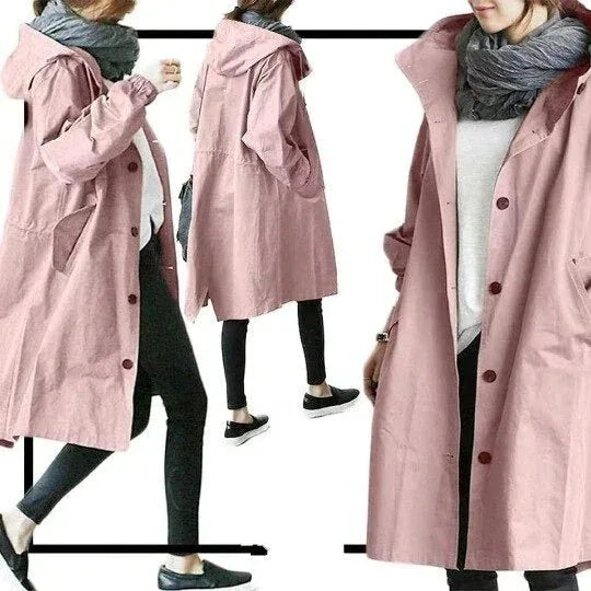 Front view of a light grey hooded trench coat with visible black button fastenings and roomy pockets