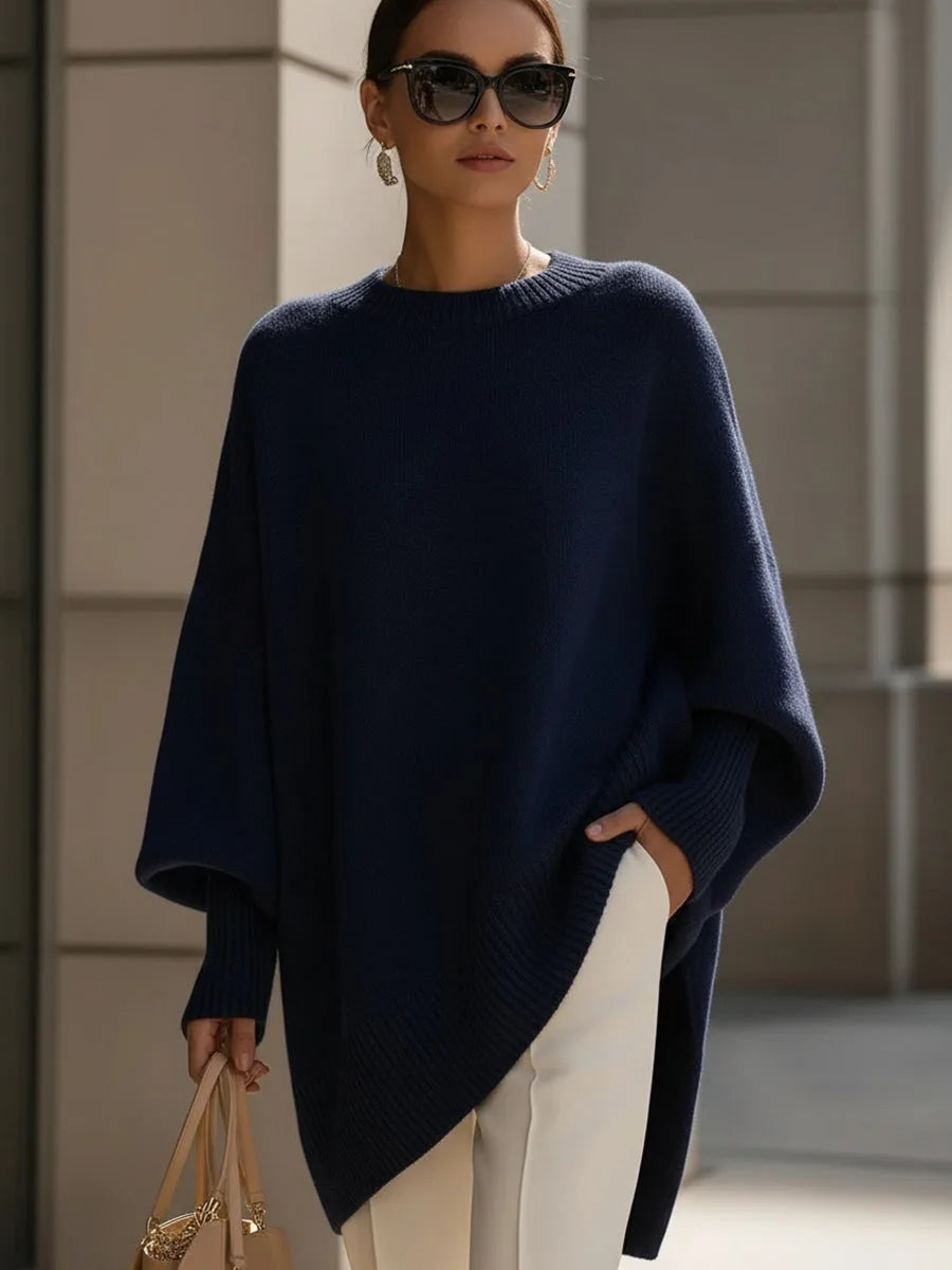 Model wearing the oversized poncho jumper in navy blue with a wide ribbed neckline and drop shoulders