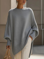 Front view of the beige jumper highlighting the round neckline and generous oversized batwing sleeves