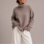 Front view of a taupe oversized polo neck jumper with ribbed cuffs, paired with cream wide-leg trousers.