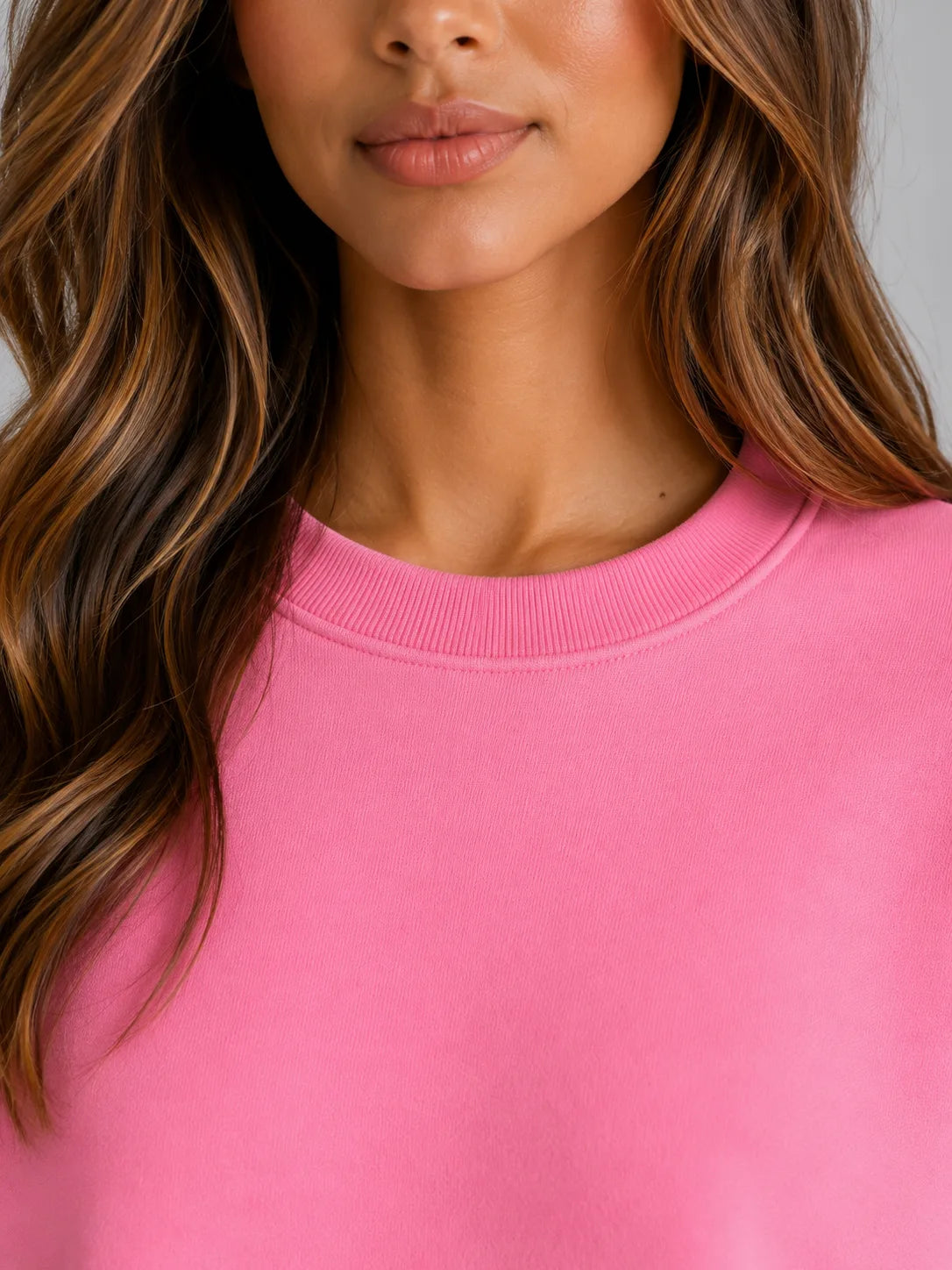 Close-up of the crew neck ribbed collar and soft brushed fabric texture in pink