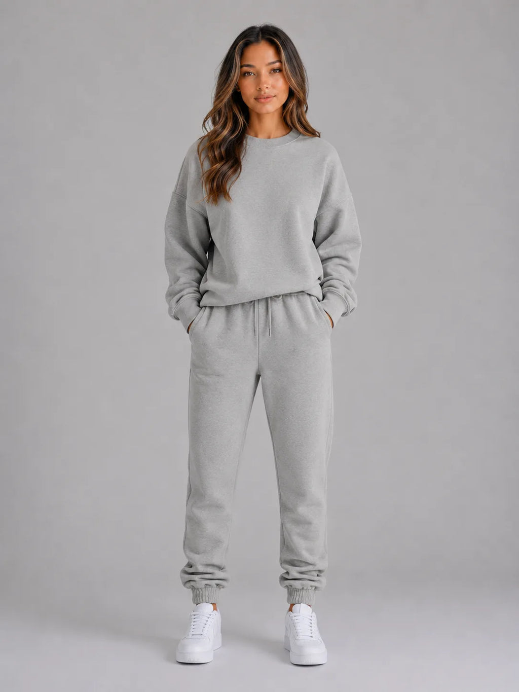 Full-length front view of the oversized tracksuit set in heather grey with white trainers