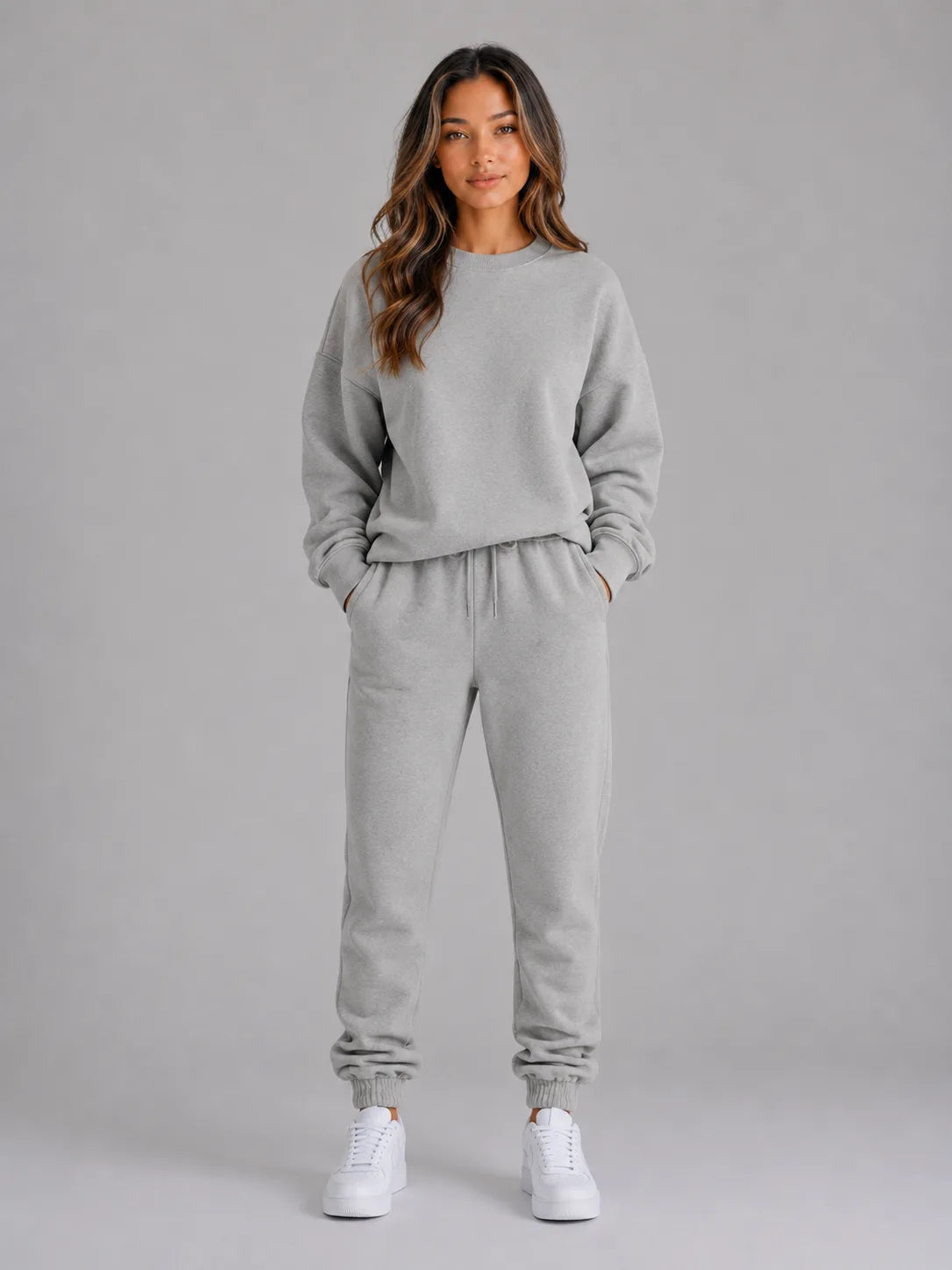 Full-length front view of the oversized tracksuit set in heather grey with white trainers