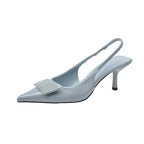 Angled studio shot of a pale blue patent slingback pump with pointed toe and squared buckle accent on a plain background