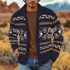 Man wearing a navy blue zip cardigan with cream and tan Aztec-style knit pattern, shawl collar, paired with a brown jumper and jeans