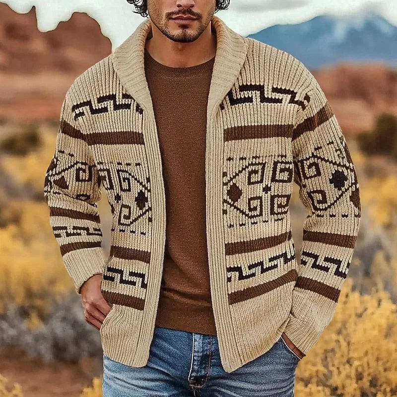 Man wearing the khaki zip cardigan with brown Aztec-style knit pattern and shawl collar, layered over a brown jumper and jeans