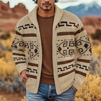 Man wearing the khaki zip cardigan with brown Aztec-style knit pattern and shawl collar, layered over a brown jumper and jeans