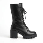 Side profile of black lace-up combat boot with chunky lug platform sole and block heel against a white background