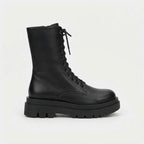 Side profile of black grained leather lace-up combat boot with chunky lugged platform sole