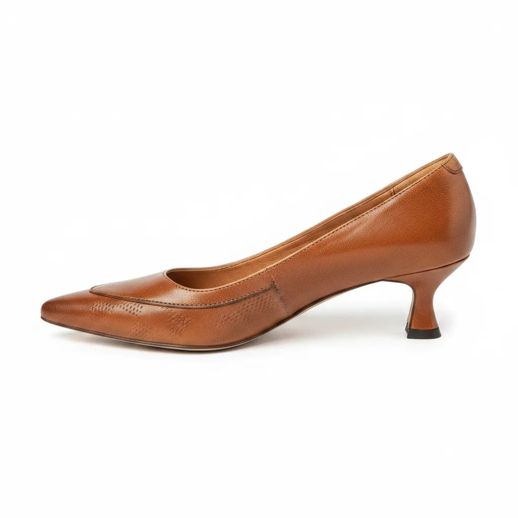 Side profile of tan brown leather kitten heel pump showing pointed toe and curved low heel
