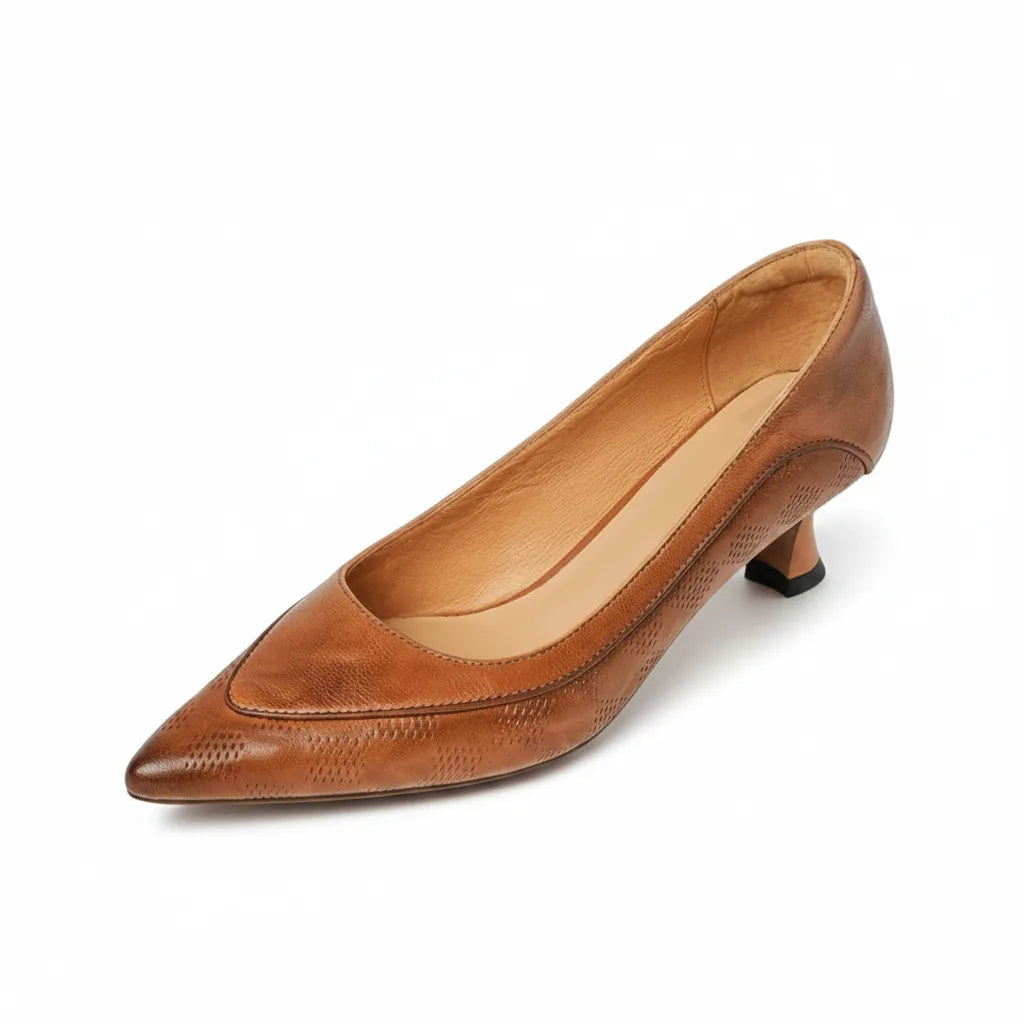 Angled front-side view of brown leather pump highlighting stitched vamp panel and slim heel
