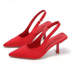 Bright red satin slingback pumps highlighting the pointed toe and kitten heel shape