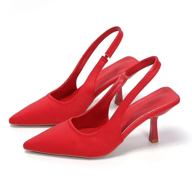 Bright red satin slingback pumps highlighting the pointed toe and kitten heel shape
