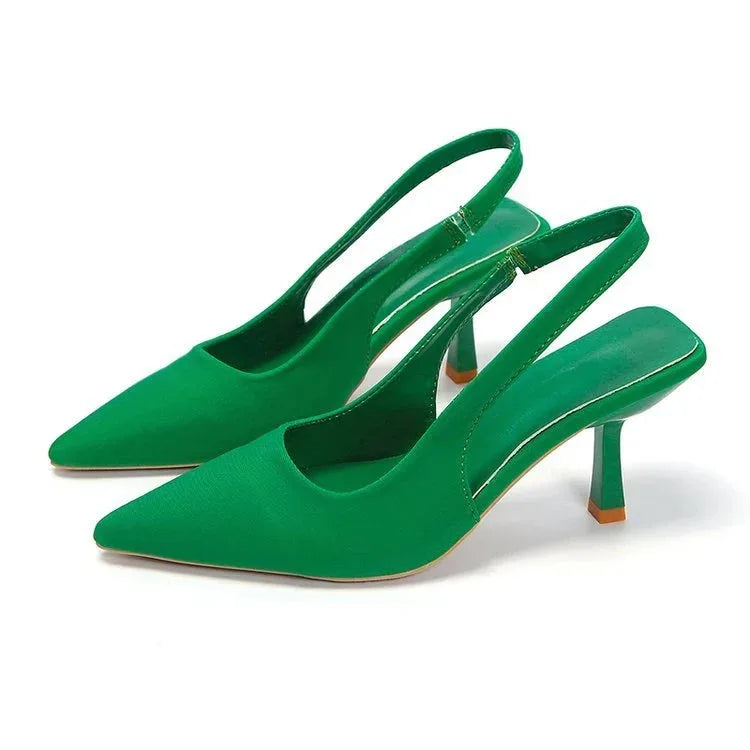 Emerald green slingback pumps showing the pointed toe, sling strap and tapered heel from the side