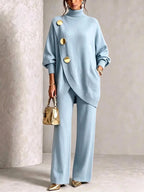 Pale blue two-piece knit set showing the flowing wide-leg trousers and side pocket detail