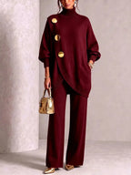 Close front view of the burgundy knit set showing the ribbed trim and three polished gold buttons on the tunic