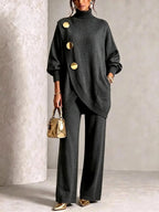 Charcoal grey knit set worn with pointed gold mule heels, highlighting the wide-leg trouser silhouette