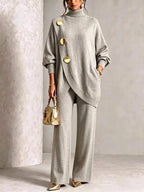 Full-length side view of the light grey polo neck tunic and trouser set draped over a relaxed drop shoulder