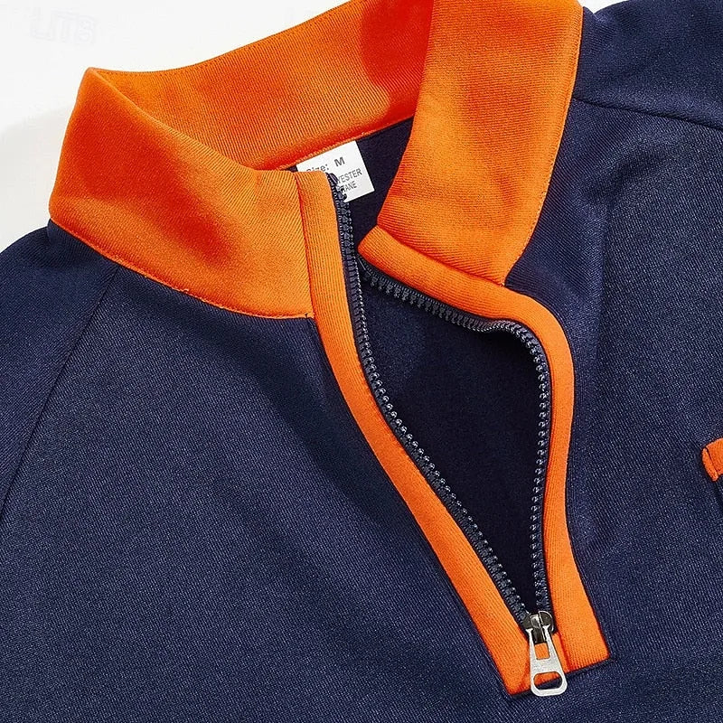 Close-up of the orange funnel collar and zip pull on the navy blue quarter-zip pullover