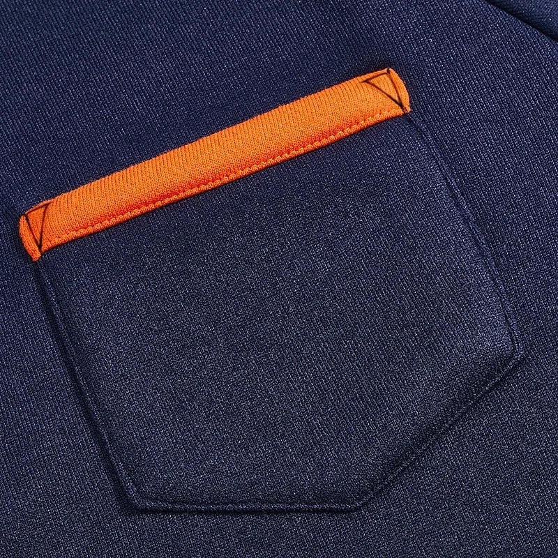 Close-up of the chest pocket with orange trim on the navy blue quarter-zip pullover