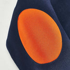 Close-up of the orange elbow patch stitched onto the navy blue sleeve