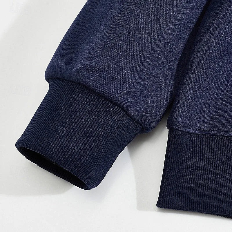 Close-up of the ribbed cuff and raglan sleeve seam on the navy blue pullover