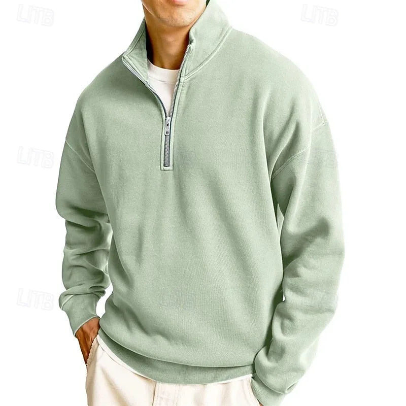 Man wearing a pink quarter-zip sweatshirt, three-quarter view showing relaxed oversized silhouette