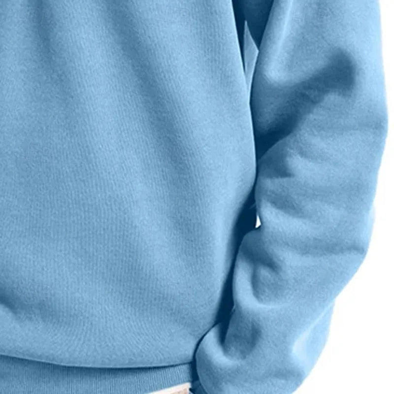 Angled shot of a grey quarter-zip sweatshirt showing the drop shoulder seam and sleeve length