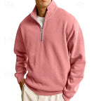 Side view of a dusty pink quarter-zip sweatshirt with ribbed cuffs and hem worn over a white tee