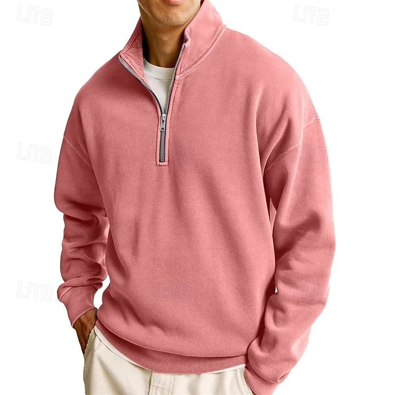 Side view of a dusty pink quarter-zip sweatshirt with ribbed cuffs and hem worn over a white tee