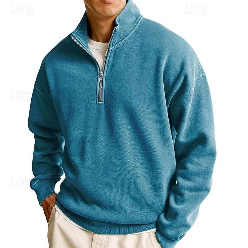 Front view of a teal blue quarter-zip sweatshirt with visible ribbed collar and cuff detailing