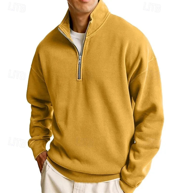 Close-up of the zip pull and stand collar on a navy blue quarter-zip sweatshirt
