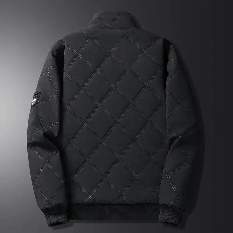 Rear view of black diamond-quilted jacket with ribbed cuffs, hem and small sleeve badge detail