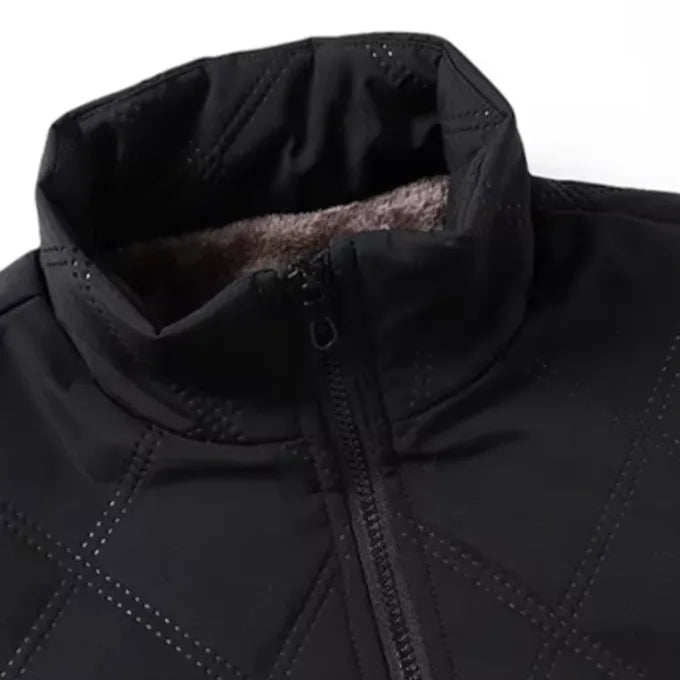 Close-up of the black stand collar unzipped, showing shell fabric against the thick fleece lining