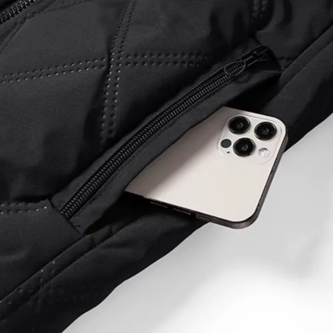 Close-up of a smartphone slipping into the exterior zipped pocket, showing pocket depth and zip pull