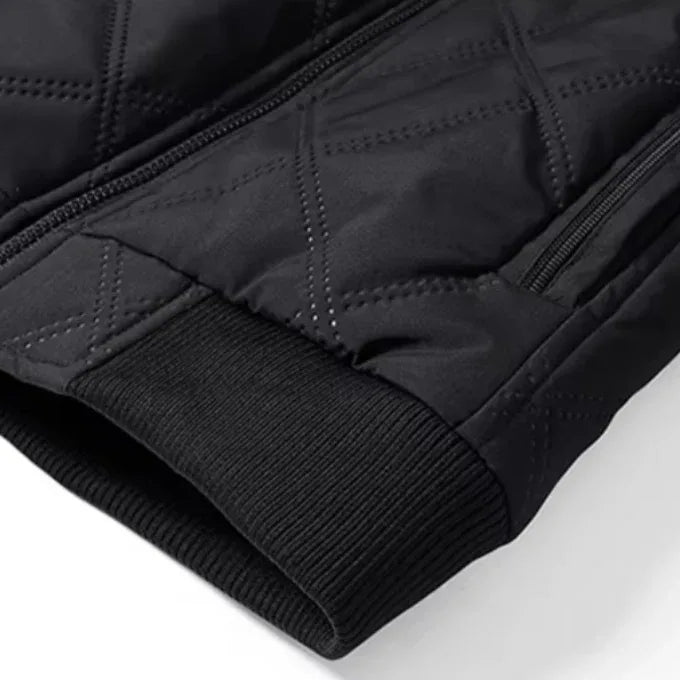 Front three-quarter view of the brown jacket highlighting the ribbed hem and cuffs against the quilted body