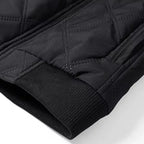 Front three-quarter view of the brown jacket highlighting the ribbed hem and cuffs against the quilted body