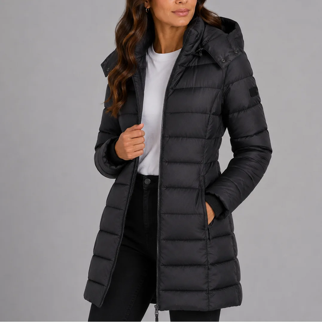 Black quilted puffer coat with detachable hood and ribbed cuffs, styled with jeans and a white t-shirt