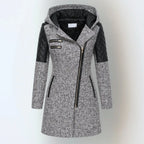 Front view of a light grey wool-blend hooded coat with black quilted leather shoulder panels and asymmetric zip