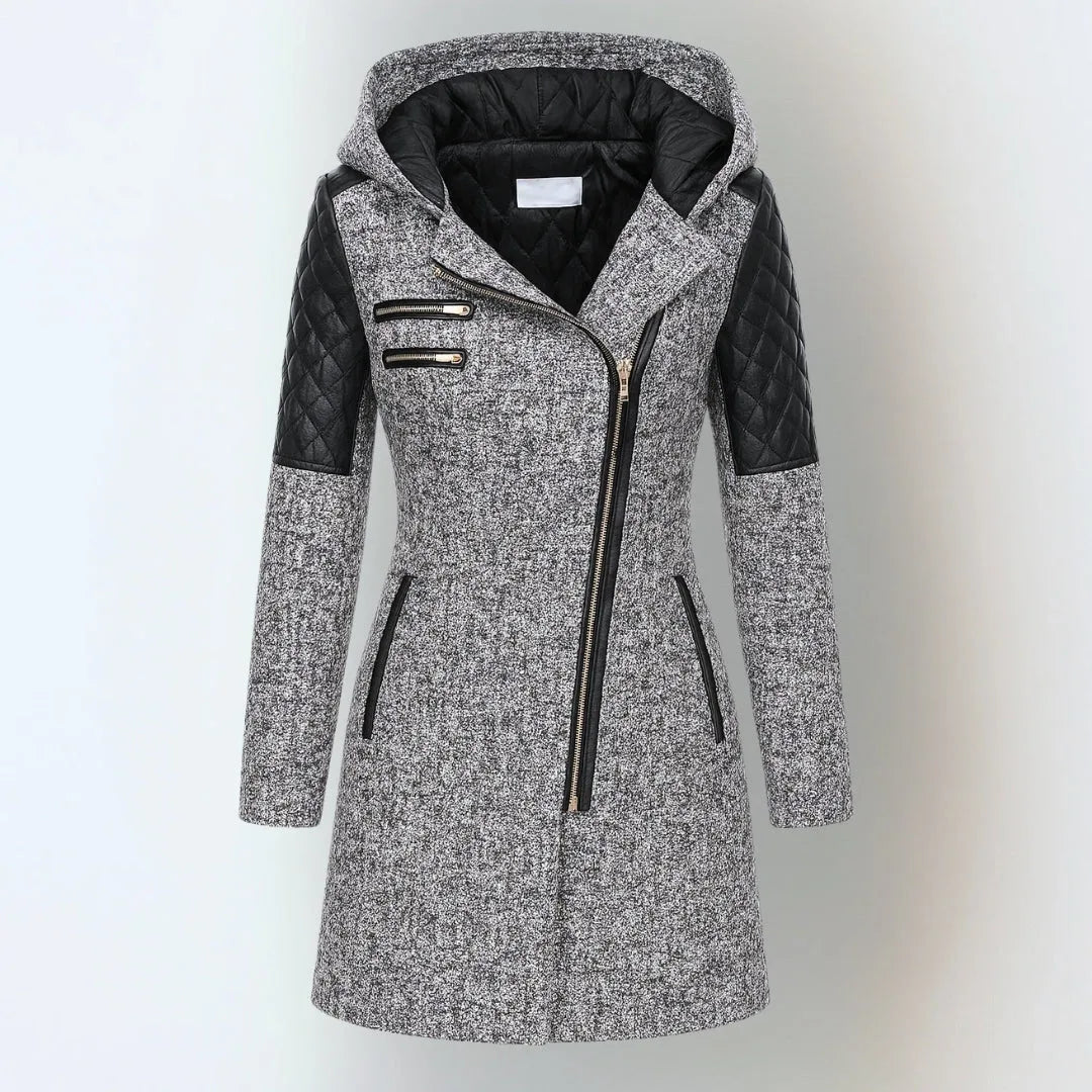 Front view of a light grey wool-blend hooded coat with black quilted leather shoulder panels and asymmetric zip