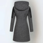 Back view of a dark grey wool-blend hooded coat with black quilted leather sleeve inserts