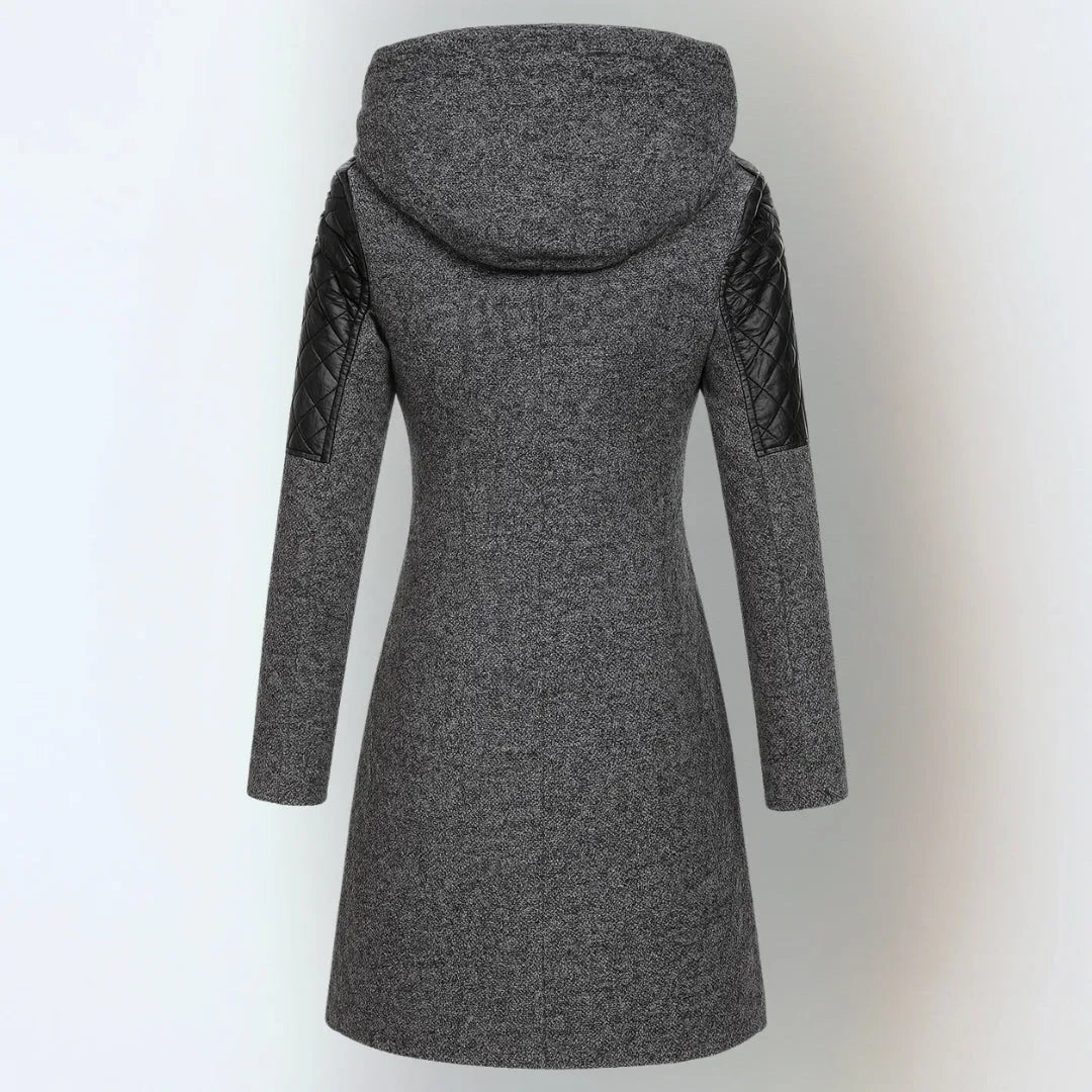 Back view of a dark grey wool-blend hooded coat with black quilted leather sleeve inserts