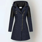 Front view of a navy blue hooded coat with black quilted leather panels and silver asymmetric zip