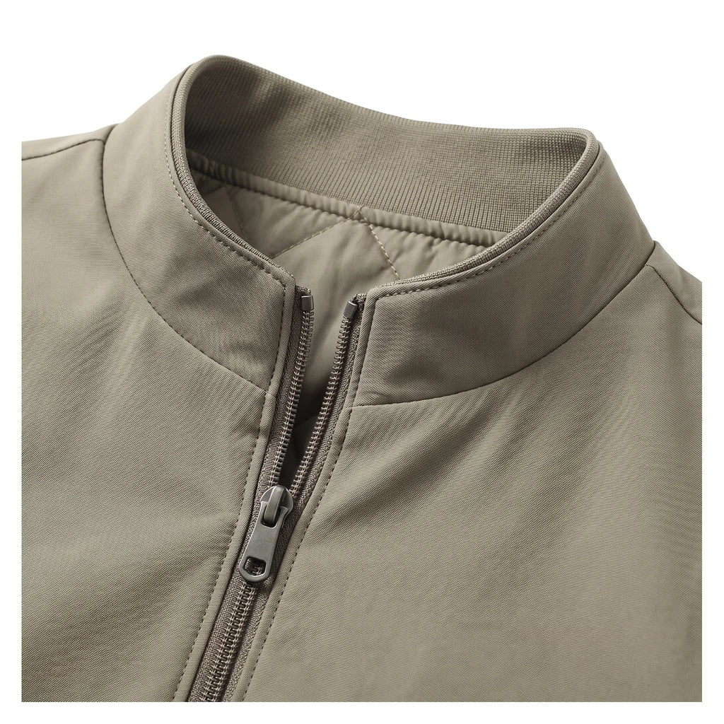 Close-up of the stand collar and zip pull showing the quilted lining detail at the neckline