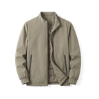 Front view of the khaki jacket half open, showing the zipped side pockets and ribbed cuffs