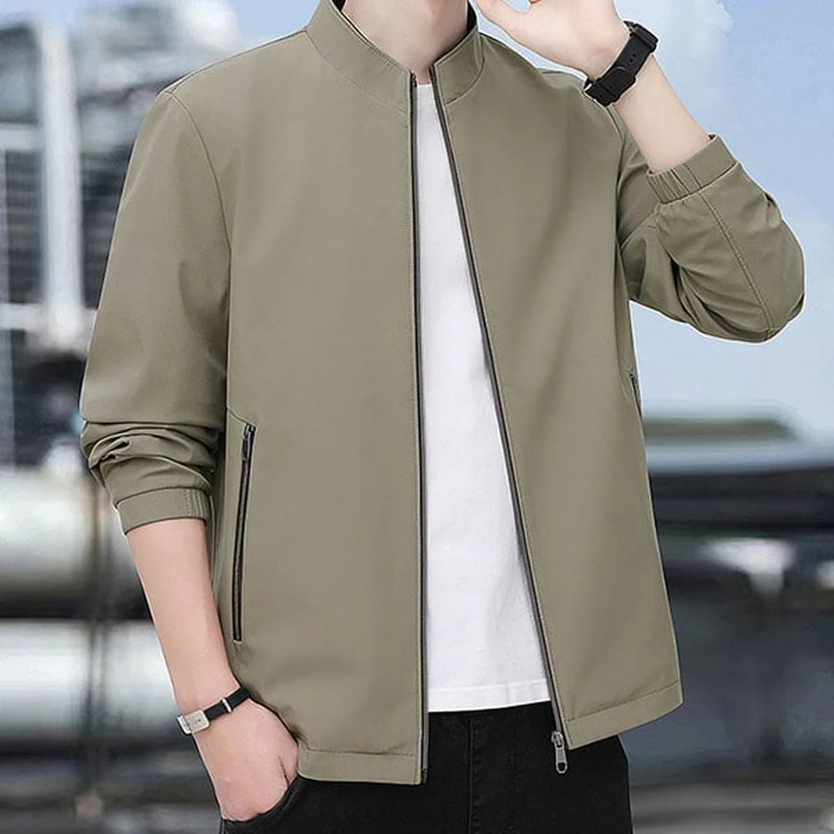 Close-up front view of the khaki jacket worn open over a white t-shirt in an outdoor setting
